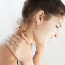 Woman Holding Her Neck in Pain